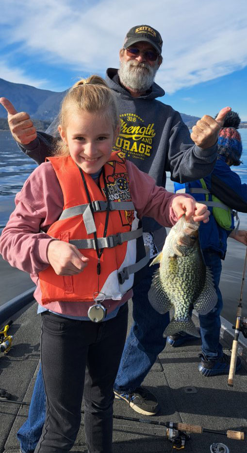 fishing-with-kids girl catches fish on lake