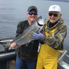 two fishermen with salmon catch